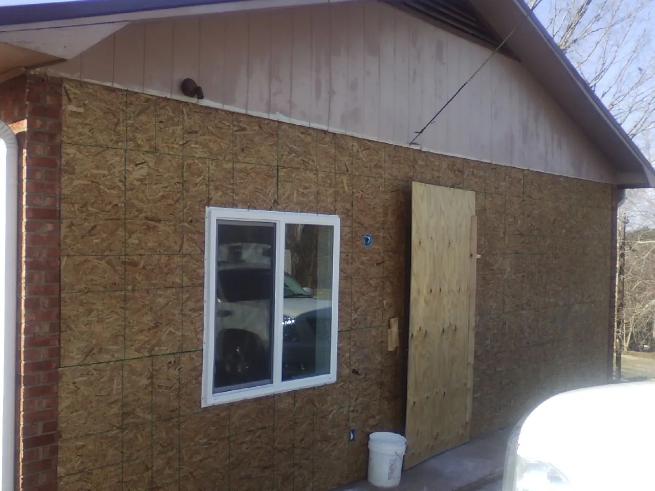 OSB sheathing on a garage addition wall before siding in Okatie