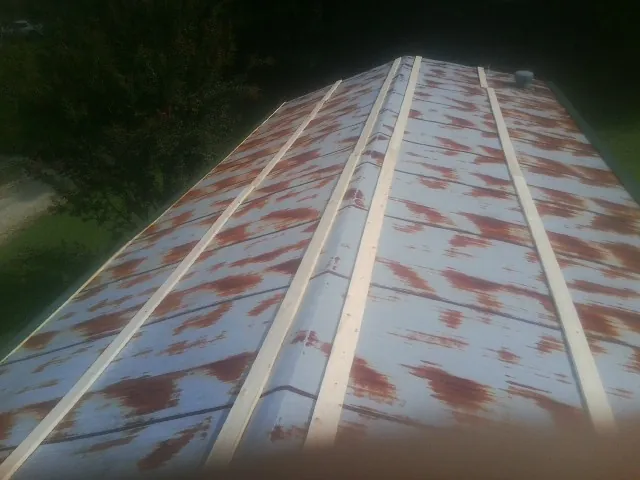 Rusted metal roof panels with new wood purlins before replacement — Storm Damage Roof Repair in Okatie by Roofing Brothers